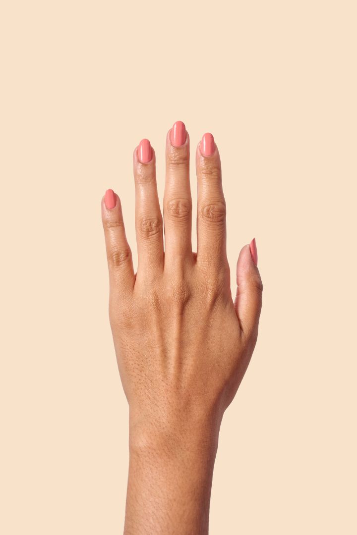 Pink coral crème nail polish inspired by the vibrant spirit of Caribbean Carnival, from the Masquerade Collection.