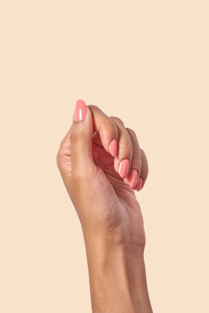 Pink coral crème nail polish inspired by the vibrant spirit of Caribbean Carnival, from the Masquerade Collection.