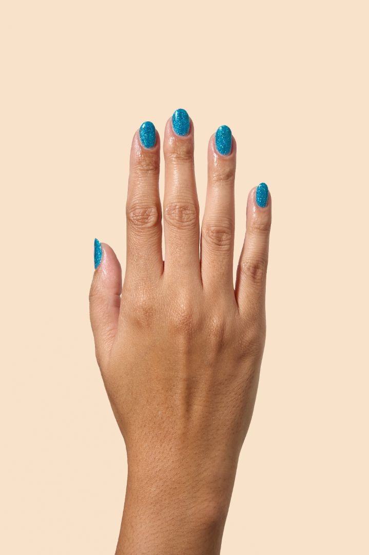 Sparkling blue glitter nail polish inspired by holiday magic, from the Screen and Sparkles collection.