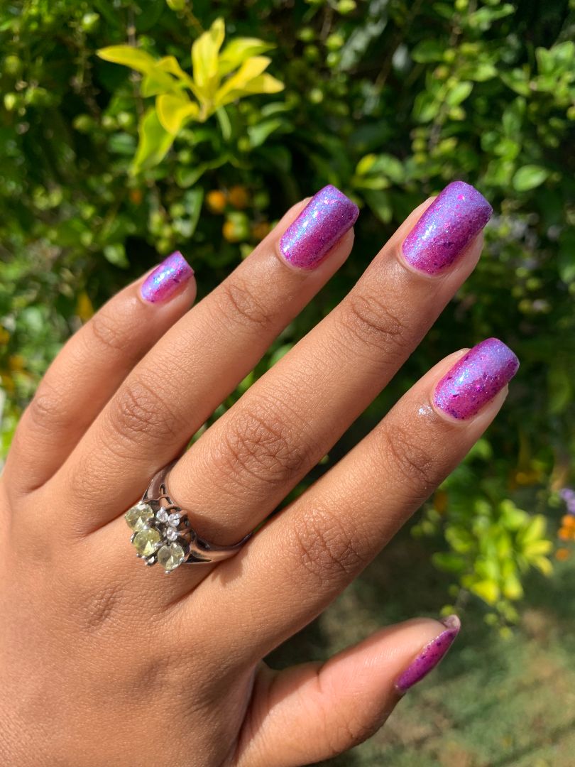 Purple nail polish with magenta flakies inspired by disco glam, from the Studio 54 Collection.