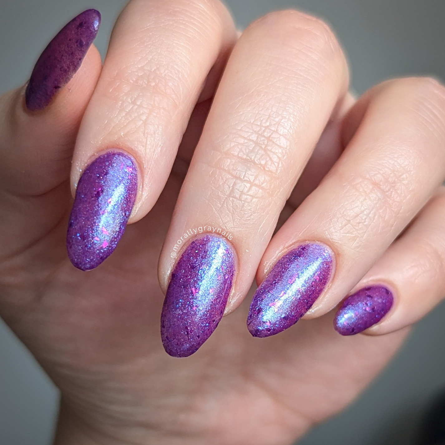 Purple glitter nail polish with magenta flakies inspired by disco glam, from the Studio 54 Collection.