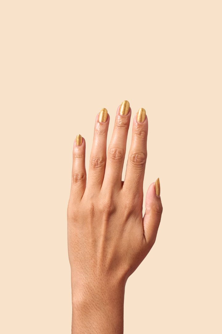 Radiant gold glitter nail polish with eco-friendly sparkle, inspired by Caribbean celebration, from the Masquerade Collection.