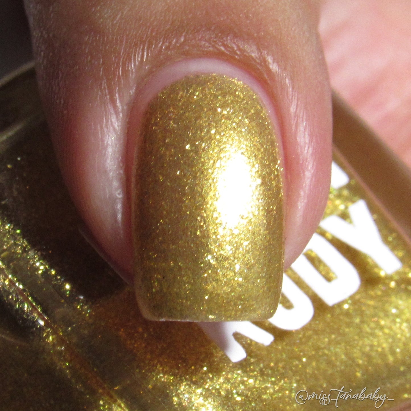 Radiant gold glitter nail polish with eco-friendly sparkle, inspired by Caribbean celebration, from the Masquerade Collection.