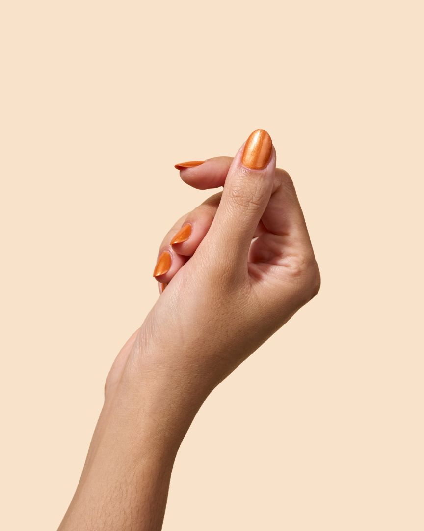 Orange copper shimmer nail polish with bold retro energy, from the Studio 54 Collection.