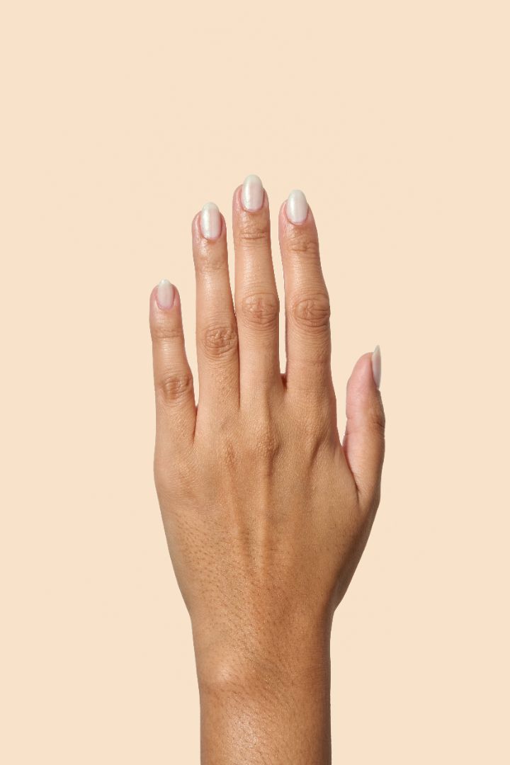 White shimmer nail polish with a soft gold glow from the Screen and Sparkles collection