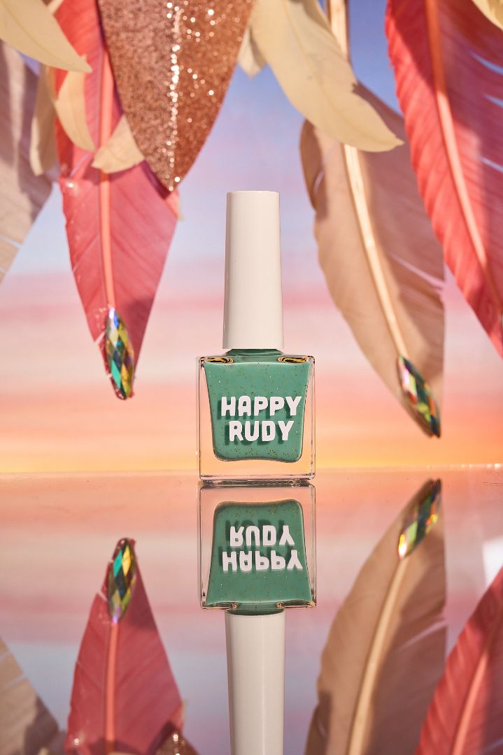 Teal glitter nail polish inspired by Caribbean J’ouvert celebrations, from the Masquerade Collection.