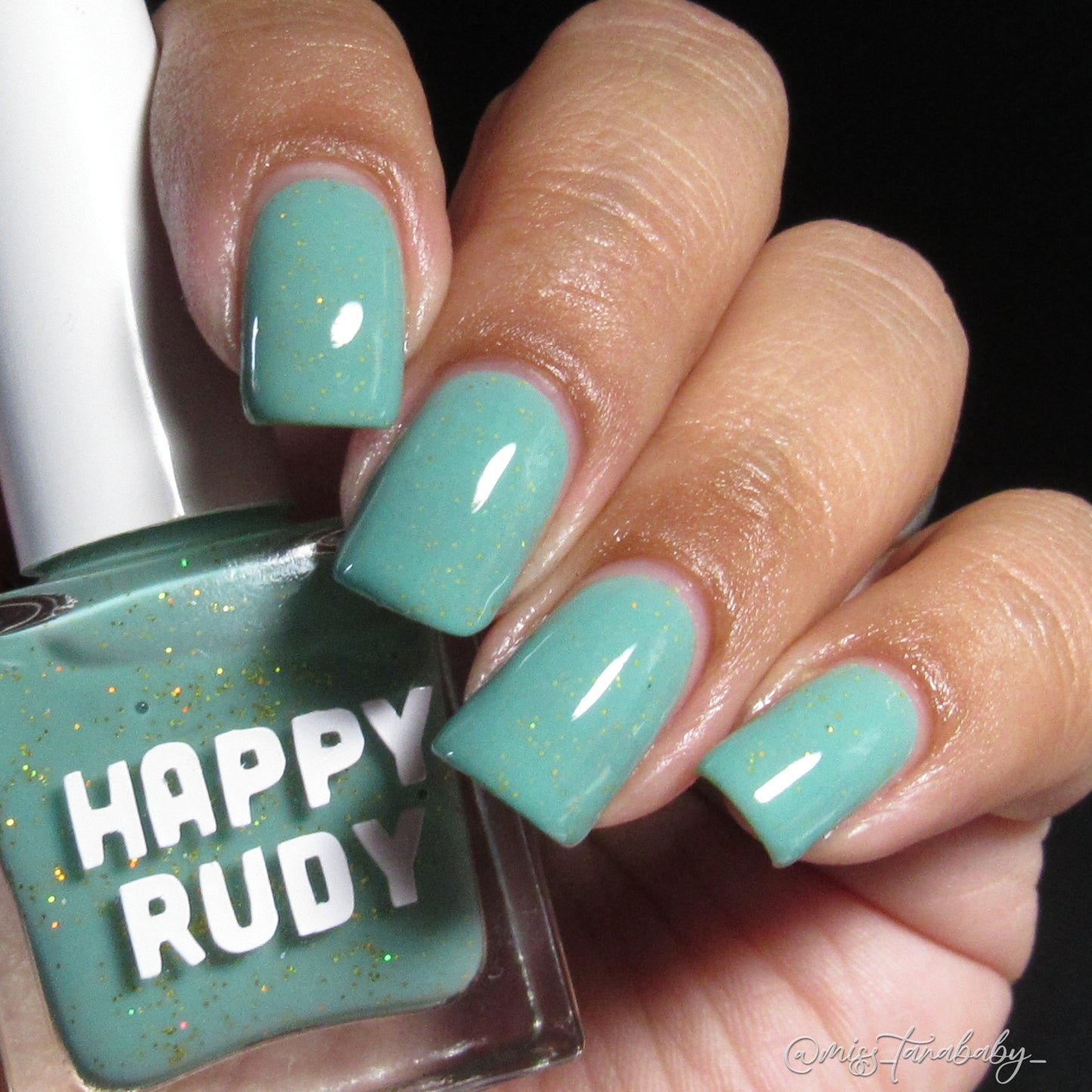 Teal glitter nail polish inspired by Caribbean J’ouvert celebrations, from the Masquerade Collection.