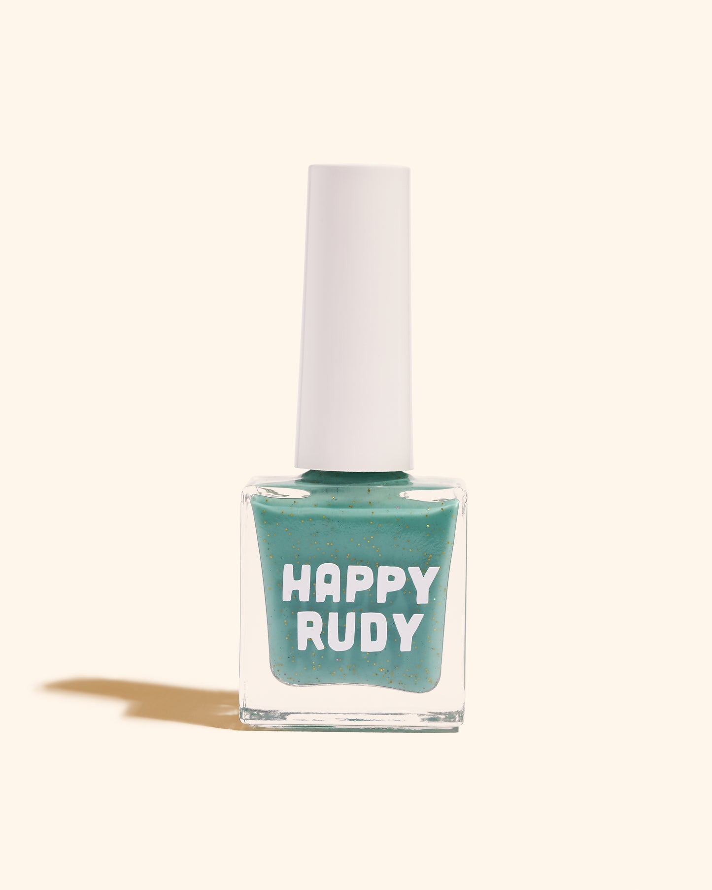 Teal glitter nail polish inspired by Caribbean J’ouvert celebrations, from the Masquerade Collection.