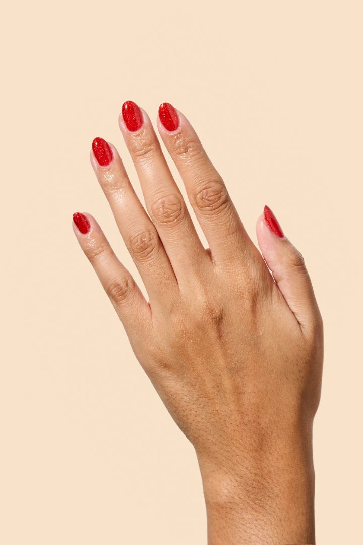 Bold ruby red glitter nail polish perfect for festive looks, part of the Screen and Sparkles collection.