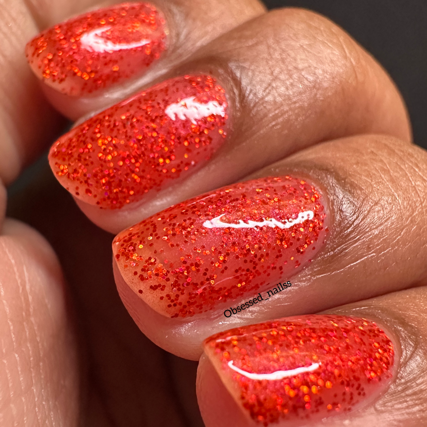 Bold ruby red glitter nail polish perfect for festive looks, part of the Screen and Sparkles collection.