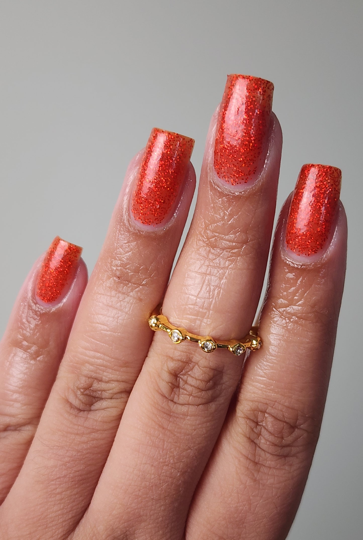Bold ruby red glitter nail polish perfect for festive looks, part of the Screen and Sparkles collection.