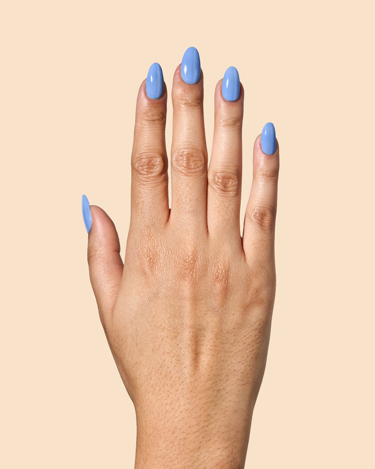 Bold cornflower blue crème nail polish for vibrant spring nails.
