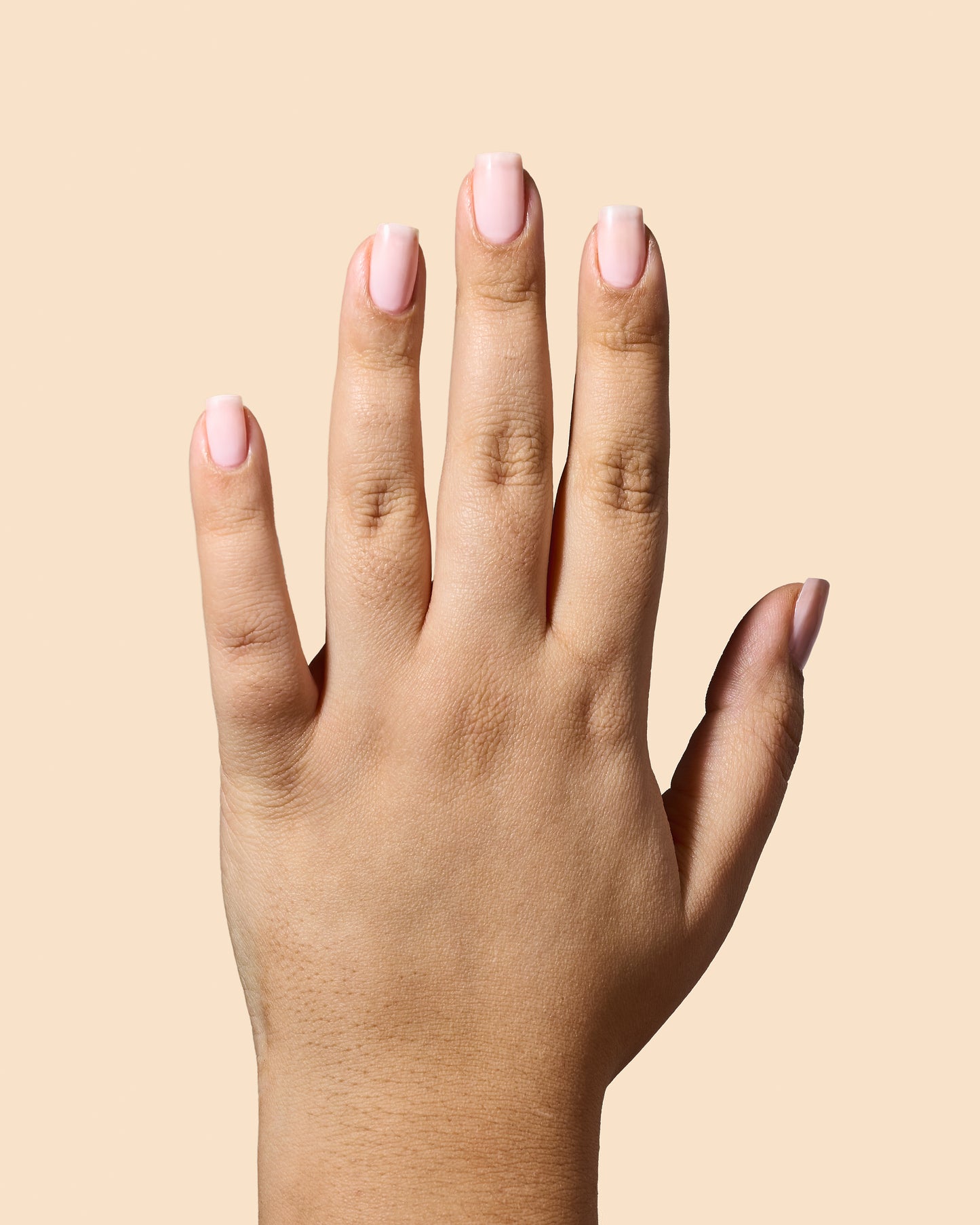 Sheer pink jelly nail polish with a high-gloss finish.