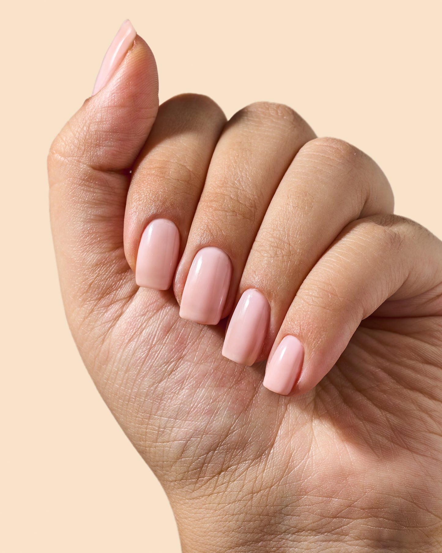 Sheer pink jelly nail polish with a high-gloss finish.