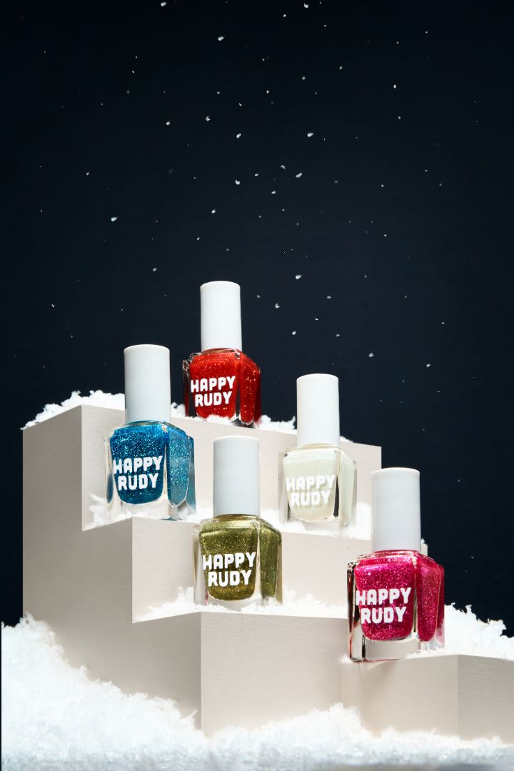 Group shot of the Screen and Sparkles Collection featuring five festive glitter and shimmer nail polishes in red, pink, white, green, and blue.