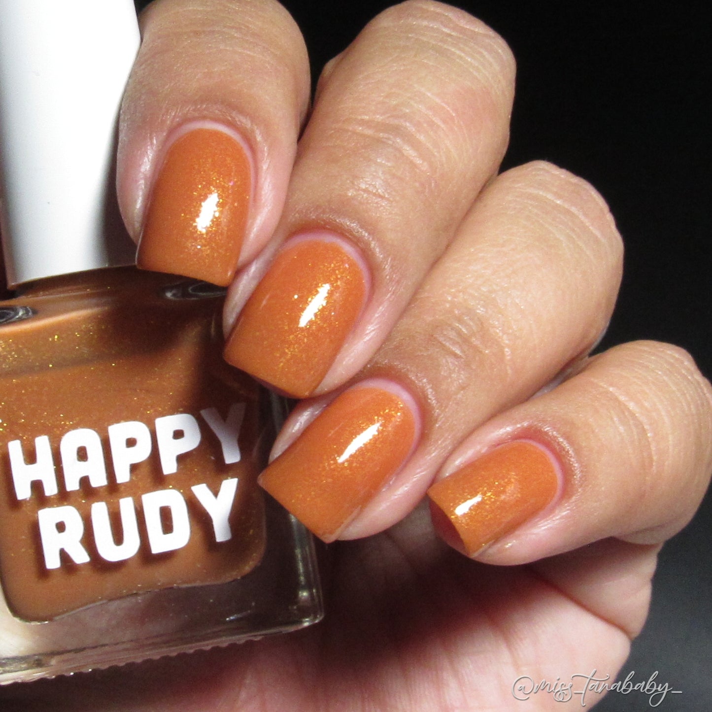 Caramel brown nail polish with gold eco-friendly glitter from the Masquerade Collection.