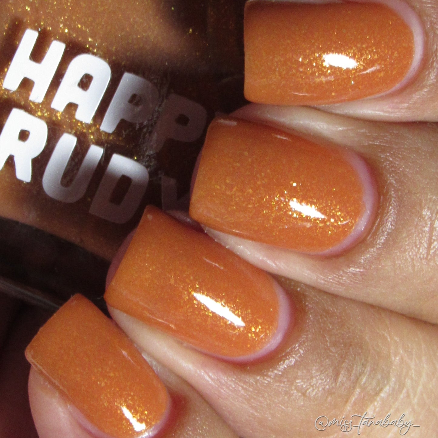 Caramel brown nail polish with gold eco-friendly glitter from the Masquerade Collection.