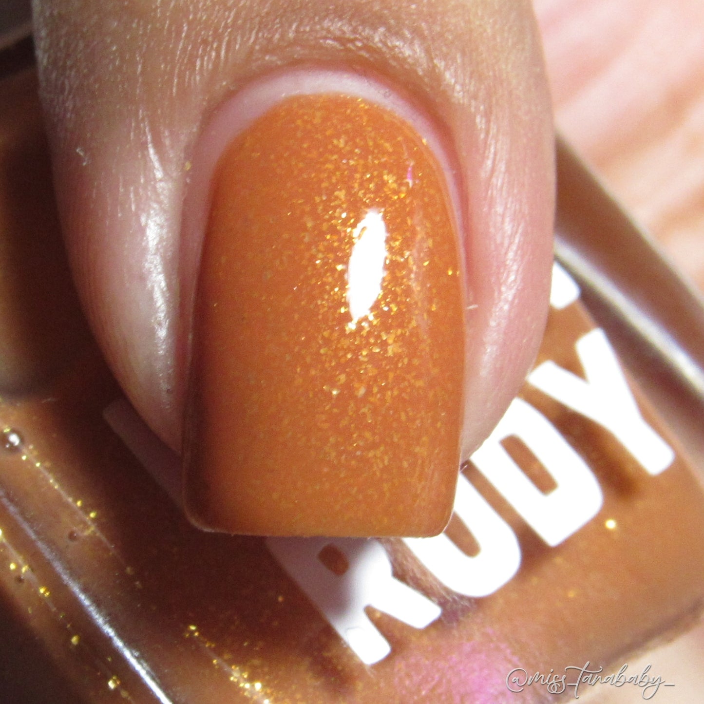 Caramel brown nail polish with gold eco-friendly glitter from the Masquerade Collection.