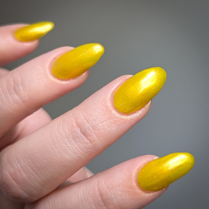 Four-On-The-Floor: a radiant yellow gold shimmer nail polish lacquer filled with eco-friendly glitter on a light skin tone