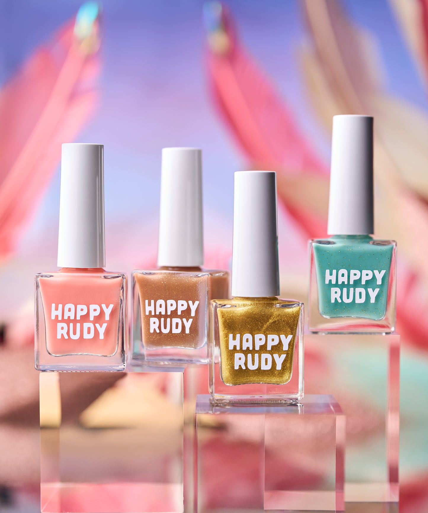 Four bottles of Happy Rudy nail polish with colorful blurred background