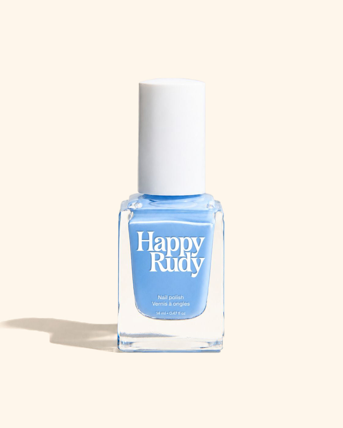 A bottle of Happy Rudy nail polish in a light sky blue shade, featuring a white cap and a clear glass bottle, set against a solid cream-colored background with a soft shadow.