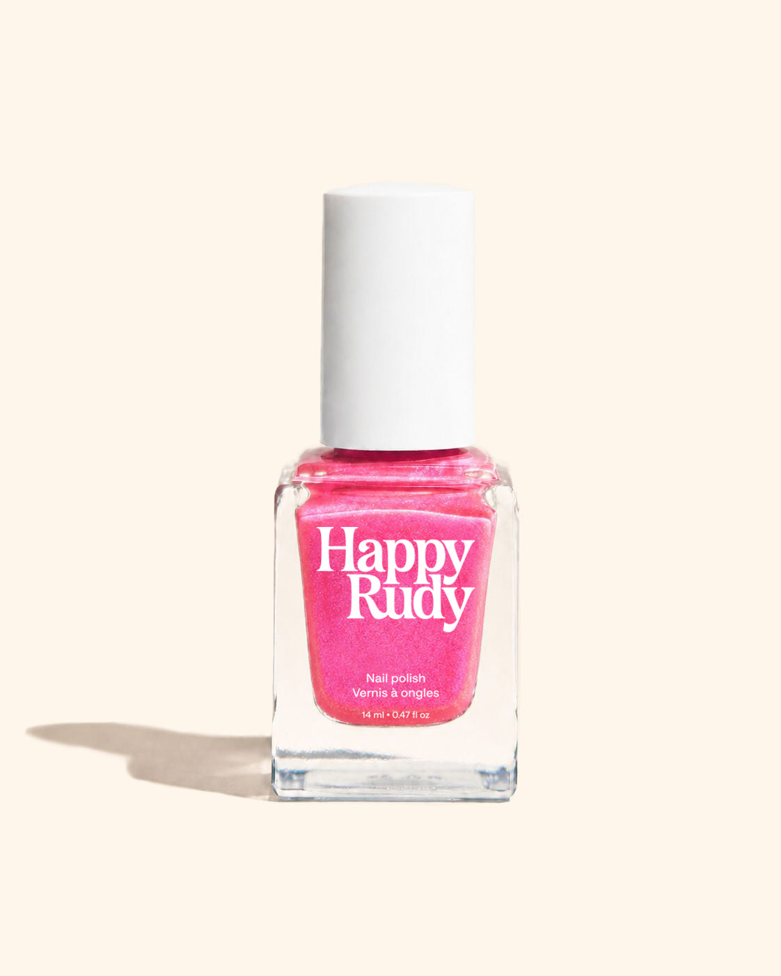 A bottle of Happy Rudy nail polish in a bright pink shade, featuring a white cap and a clear glass bottle, set against a solid cream-colored background with a soft shadow.
