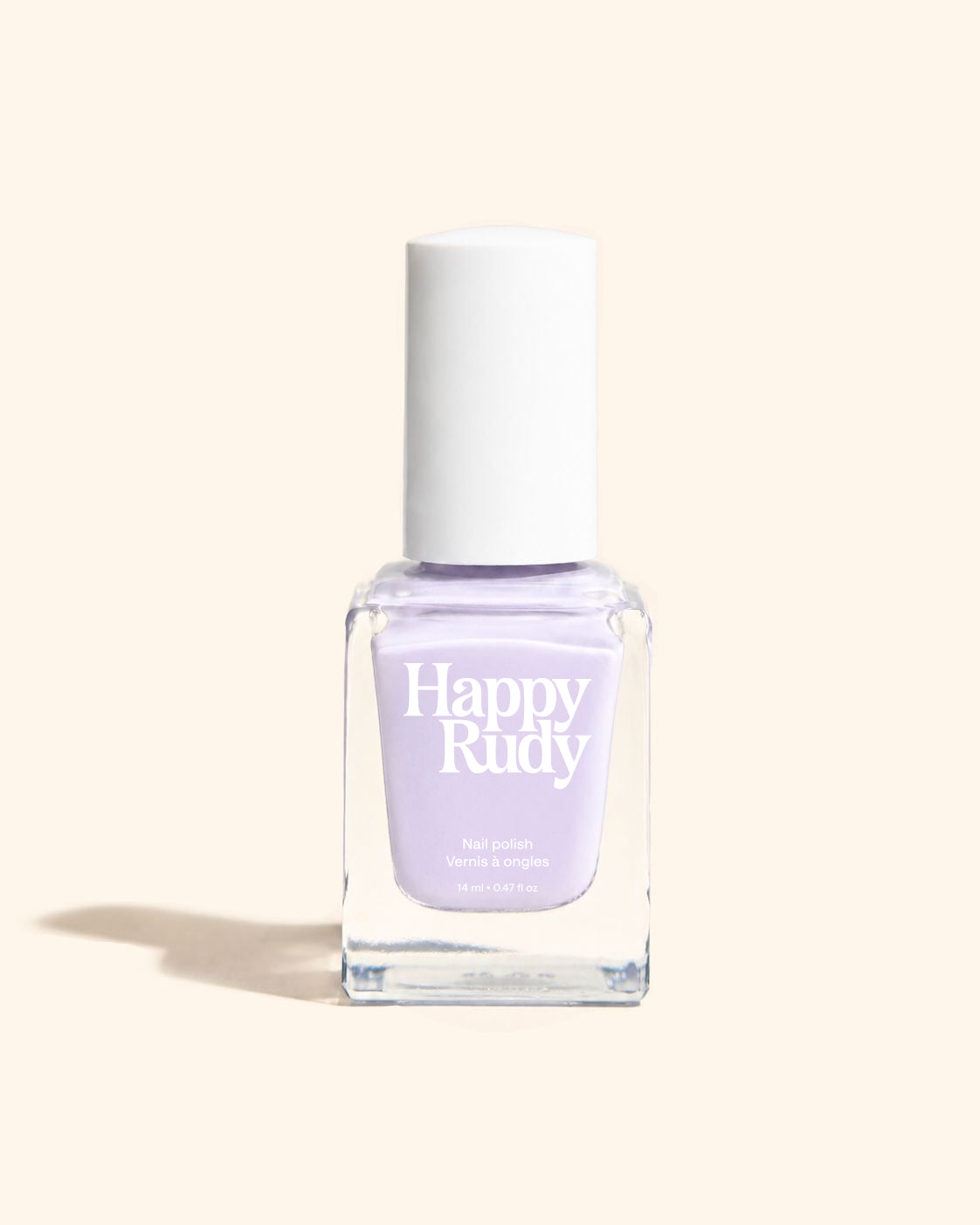 A bottle of Happy Rudy nail polish in a light lavender shade, featuring a white cap and a clear glass bottle, set against a solid cream background.