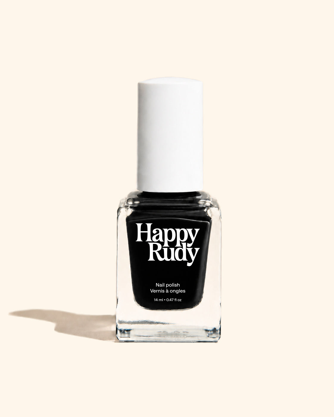 A bottle of Happy Rudy nail polish in the shade 'Venus & angles', featuring a black liquid inside a clear glass bottle with a white cap, set against a solid cream background.
