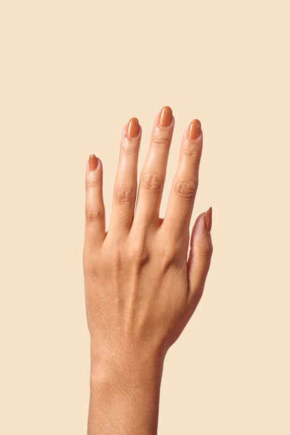 Caramel brown nail polish with gold eco-friendly glitter from the Masquerade Collection.